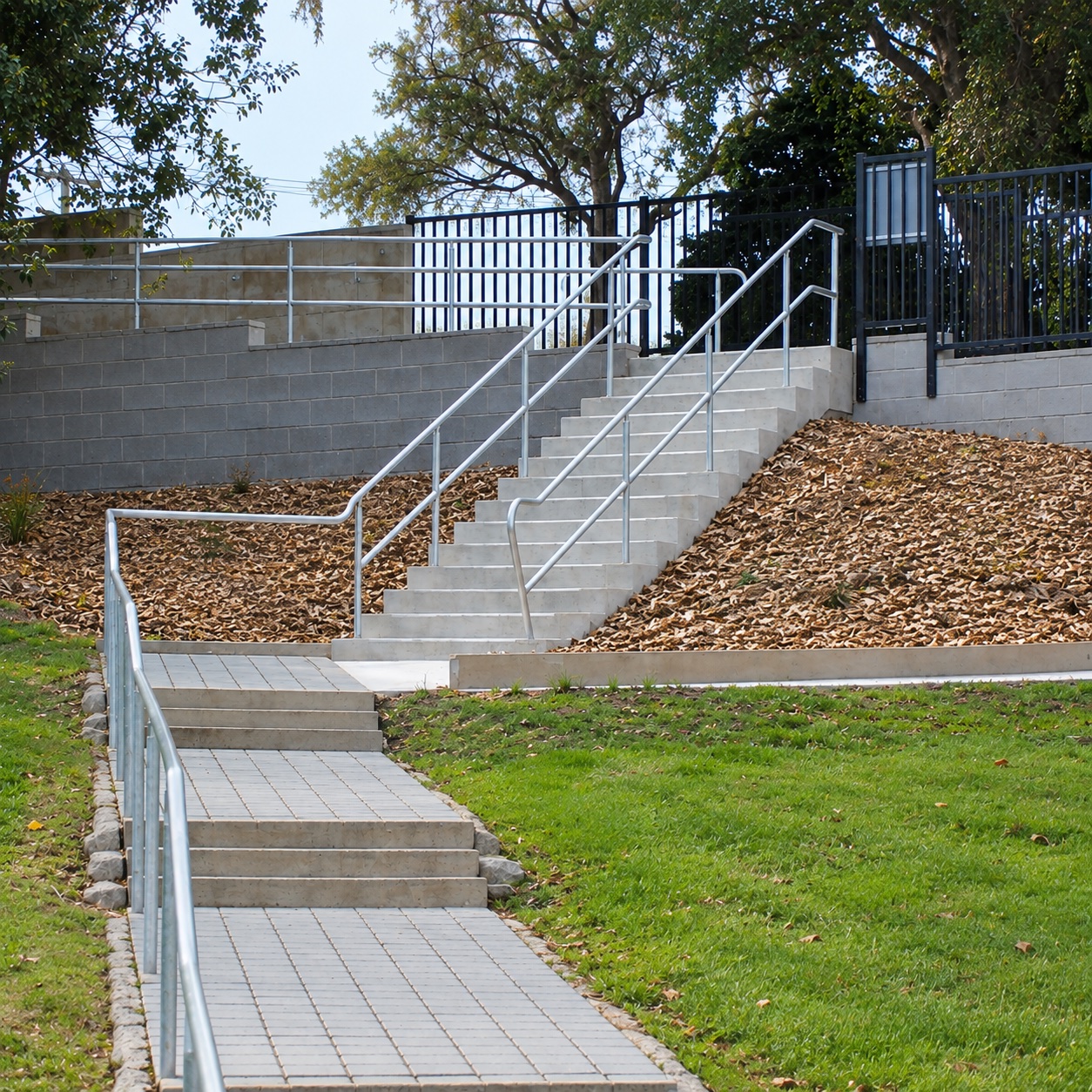 Concrete steps and handrails completed on a landscaped site